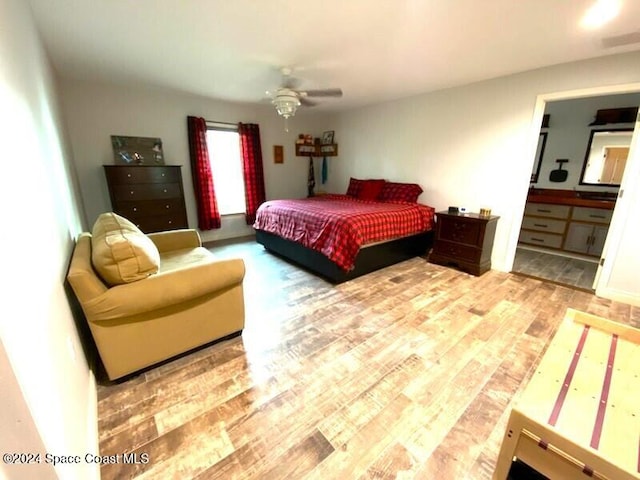 bedroom featuring ensuite bathroom, hardwood / wood-style flooring, and ceiling fan