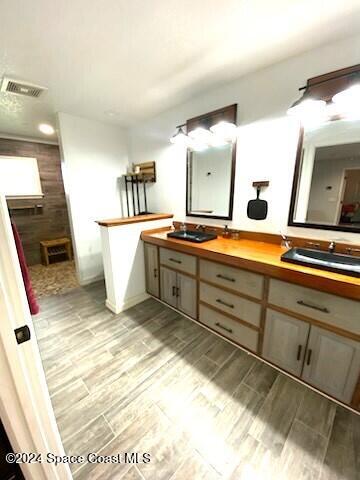 bathroom with hardwood / wood-style floors and vanity