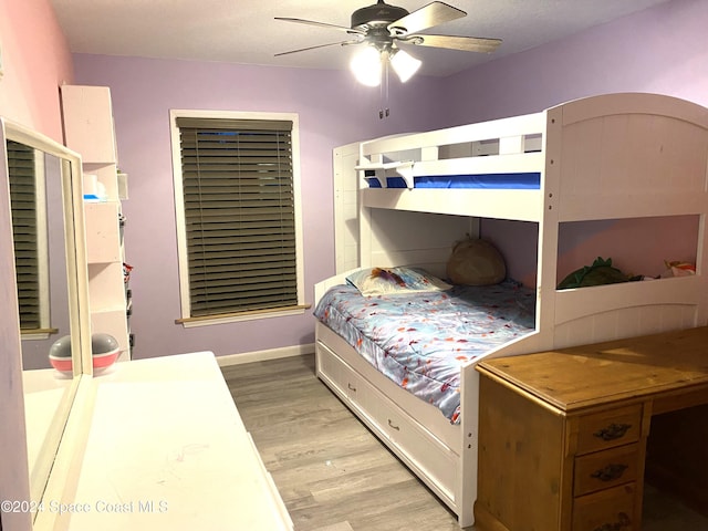 bedroom with a textured ceiling, light wood-type flooring, and ceiling fan