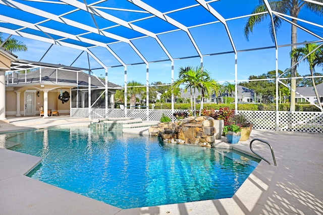 view of pool with a patio and glass enclosure