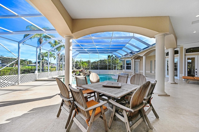 view of patio with glass enclosure, a fenced in pool, and outdoor dining space