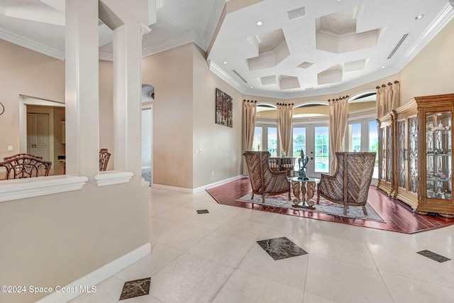 interior space with crown molding, coffered ceiling, and a high ceiling