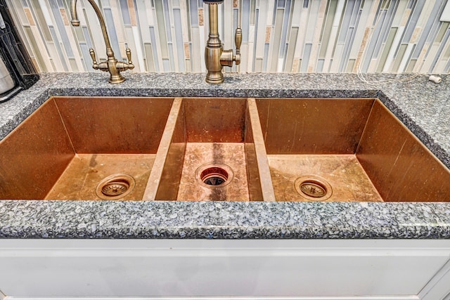 interior details with dark countertops and a sink