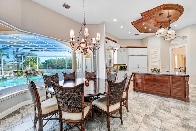 dining space featuring visible vents, baseboards, a sunroom, and stone tile flooring