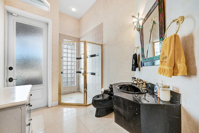 bathroom featuring vanity, toilet, tile patterned floors, and walk in shower