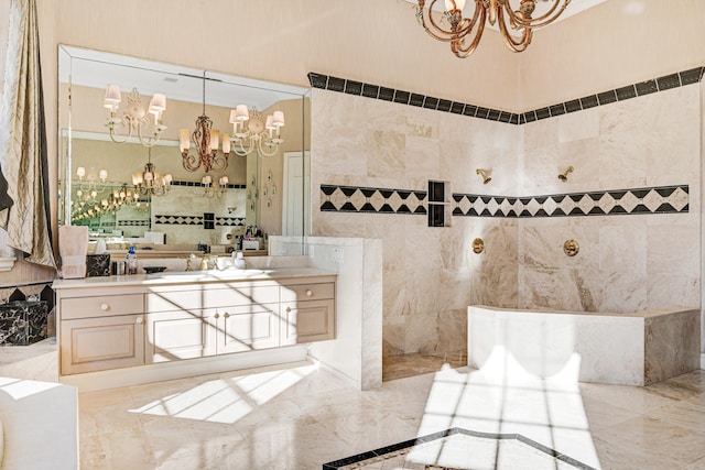 bathroom featuring tile walls, vanity, and a notable chandelier