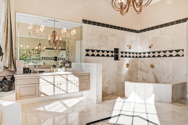 bathroom featuring tile walls, walk in shower, a notable chandelier, vanity, and marble finish floor