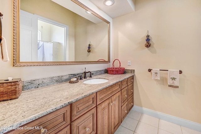 bathroom featuring a shower with curtain, baseboards, tile patterned flooring, and vanity