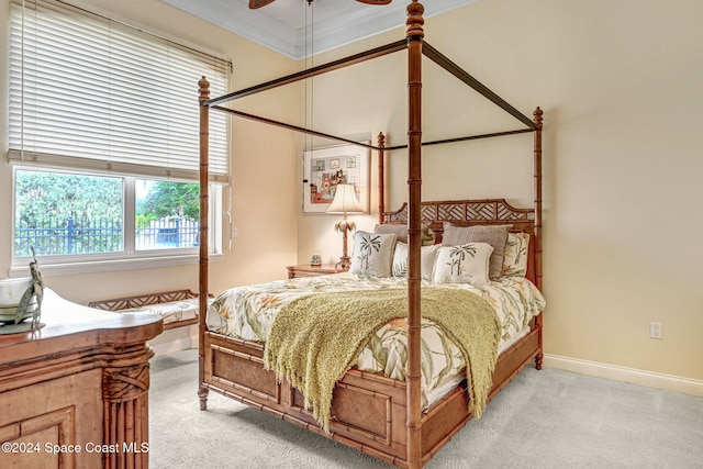 bedroom with ceiling fan, light carpet, and ornamental molding