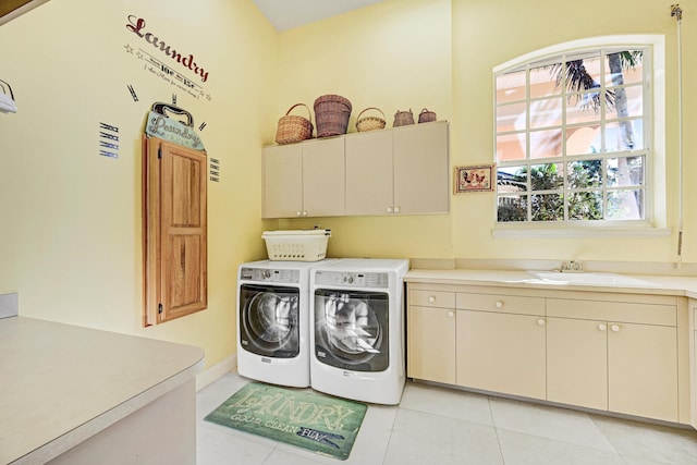 laundry area featuring separate washer and dryer, a sink, cabinet space, and light tile patterned flooring