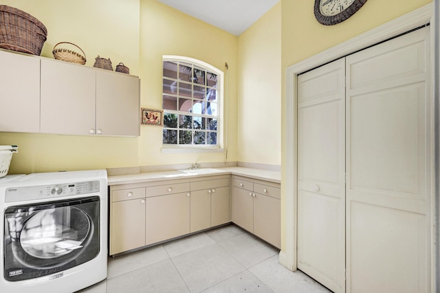 clothes washing area with a sink, cabinet space, washer / clothes dryer, and light tile patterned floors