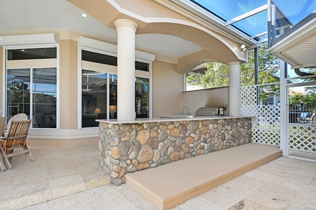 view of patio with area for grilling and an outdoor kitchen