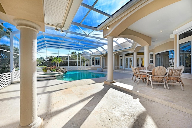 view of pool featuring a patio, glass enclosure, a pool with connected hot tub, and french doors