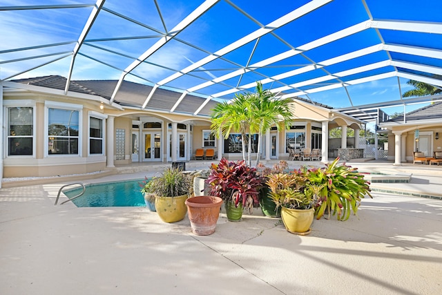 view of pool featuring french doors, a patio, and glass enclosure