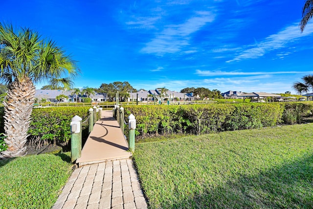 view of property's community featuring a residential view and a yard