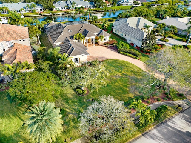 drone / aerial view featuring a residential view and a water view