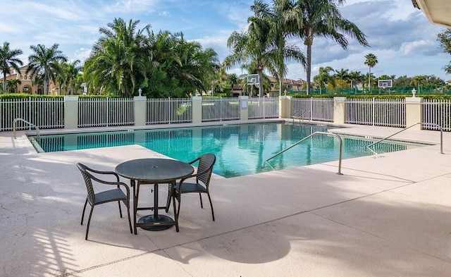 pool featuring fence and a patio