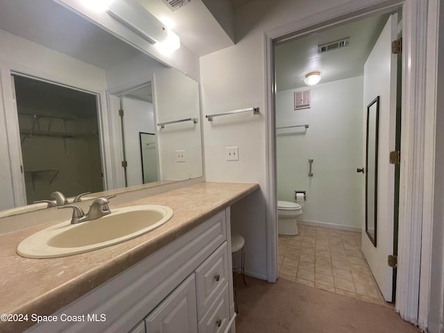 bathroom featuring vanity and toilet