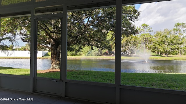 unfurnished sunroom with a water view