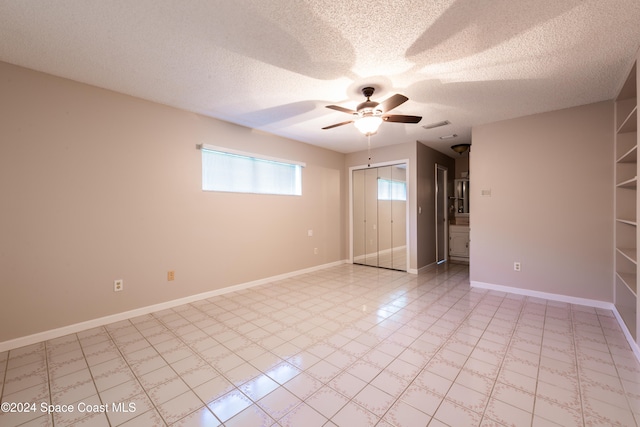 unfurnished room featuring a textured ceiling and ceiling fan