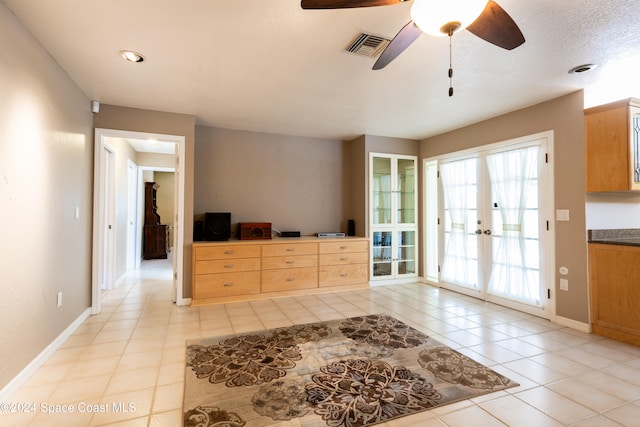 interior space with ceiling fan and french doors