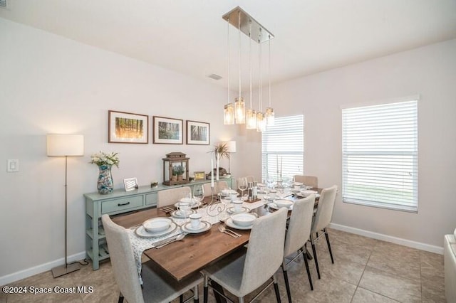 dining area with light tile patterned floors and baseboards