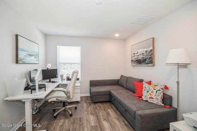 office area with visible vents, wood finished floors, and baseboards