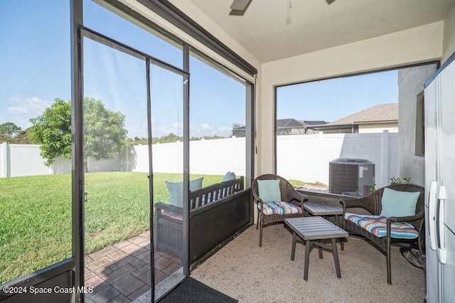 sunroom featuring a healthy amount of sunlight and a ceiling fan