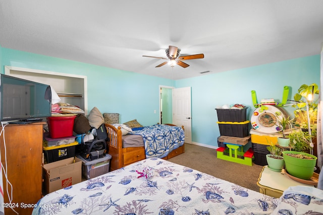 carpeted bedroom featuring a closet and ceiling fan