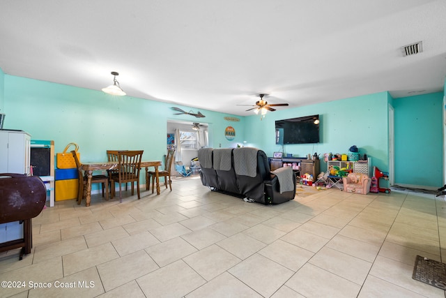 tiled living room with ceiling fan