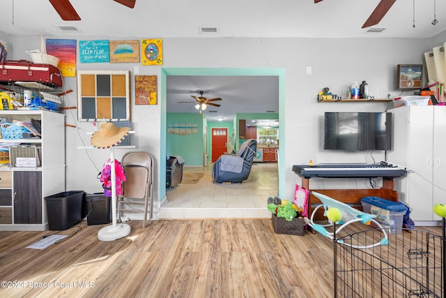 interior space with ceiling fan and hardwood / wood-style floors