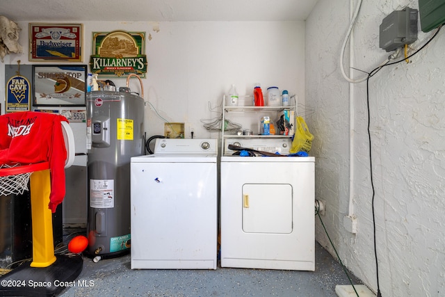 laundry area featuring electric water heater and separate washer and dryer