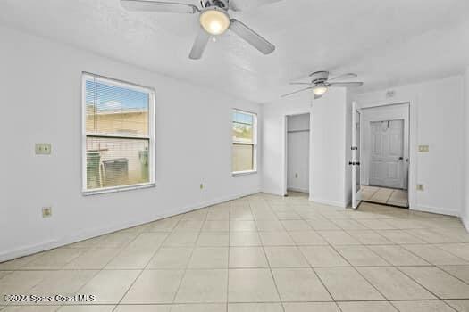 interior space with a wealth of natural light and ceiling fan