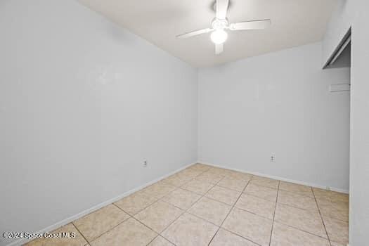 empty room featuring ceiling fan and light tile patterned floors