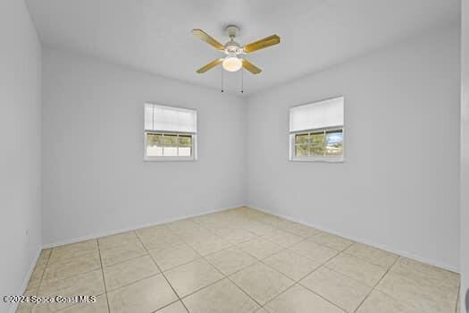 unfurnished room featuring ceiling fan and light tile patterned flooring