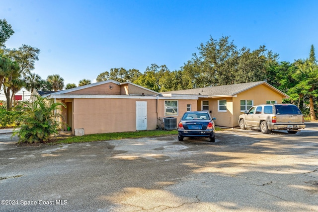 ranch-style home with central AC unit