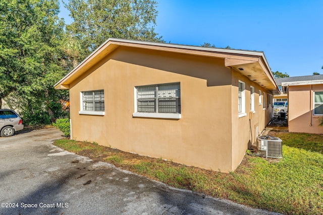 view of home's exterior with central AC and stucco siding