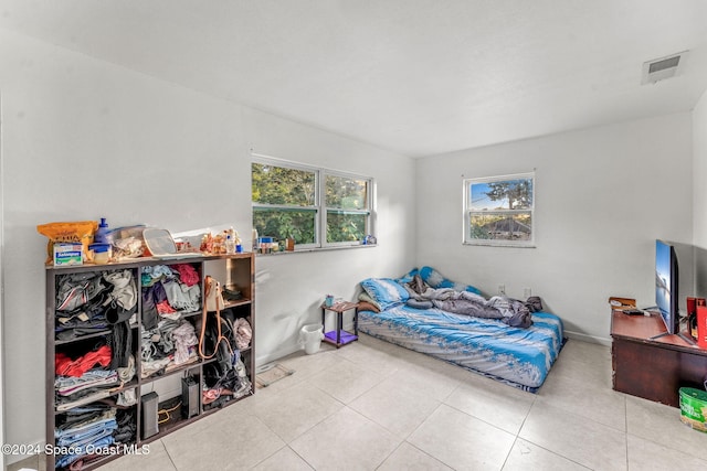 bedroom featuring tile patterned floors and baseboards