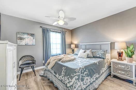 927 Jamestown Ave # 105, Indian Harbour Beach, FL 32937 - bedroom with wood finished floors, ceiling fan, and baseboards