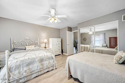 927 Jamestown Ave # 105, Indian Harbour Beach, FL 32937 - bedroom with wood finished floors and ceiling fan