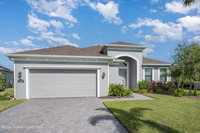 view of front of property with a front lawn and a garage