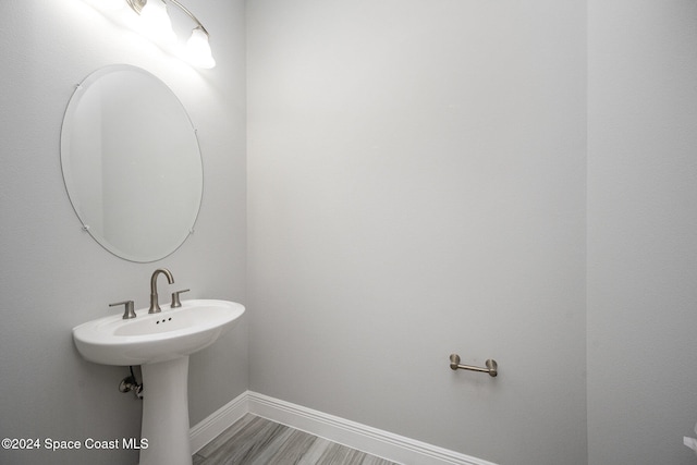 bathroom with hardwood / wood-style flooring