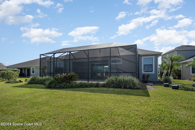 back of property featuring a yard and glass enclosure