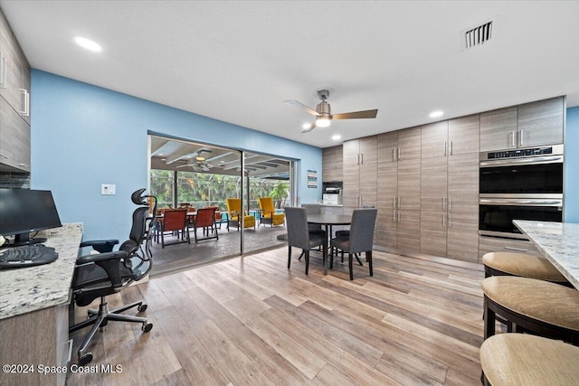 dining area with ceiling fan and light wood-type flooring