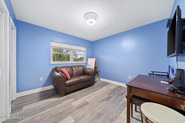 office with a textured ceiling and light hardwood / wood-style floors