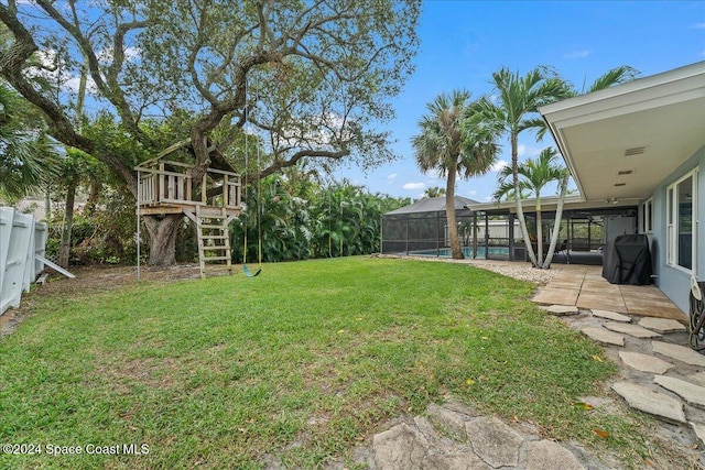 view of yard with a lanai and a patio