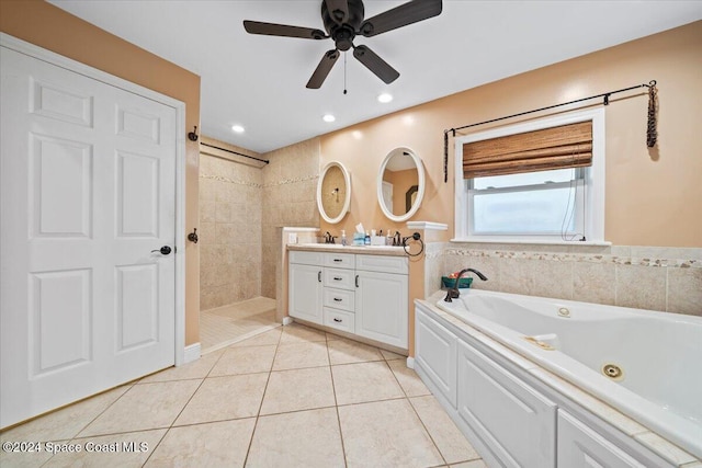 bathroom with vanity, ceiling fan, tile patterned flooring, and plus walk in shower