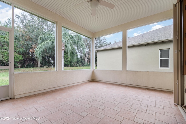 unfurnished sunroom with ceiling fan