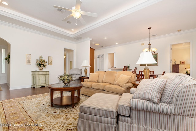 living room with ornamental molding, hardwood / wood-style floors, and ceiling fan