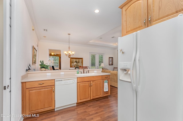 kitchen featuring white appliances, hanging light fixtures, crown molding, hardwood / wood-style flooring, and a chandelier